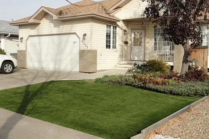 Modern landscaping with synthetic turf for homes Residential home with artificial grass lawn