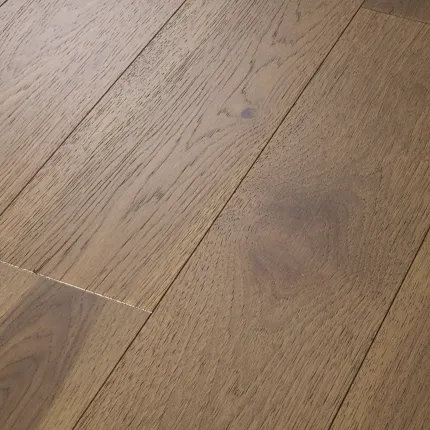 Brown Hardwood Flooring with Natural Wood Grain Texture Close-up of brown hardwood flooring with natural wood grain texture