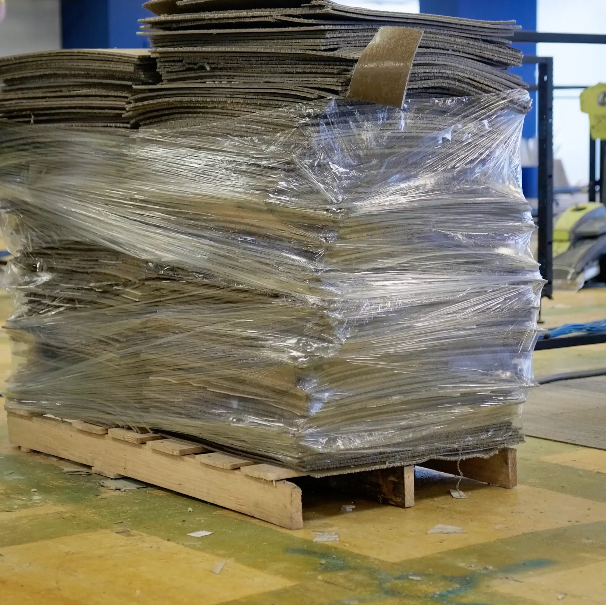 Stack of commercial carpet tiles wrapped on a pallet