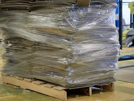 Durable commercial carpet tiles for versatile flooring solutions Stack of commercial carpet tiles wrapped on a pallet