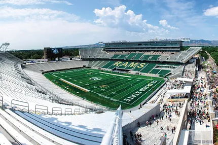 Panoramic view of Colorado State University football stadium with green turf and RAMS branding. Panoramic view of Colorado State University football stadium with green turf and RAMS branding.