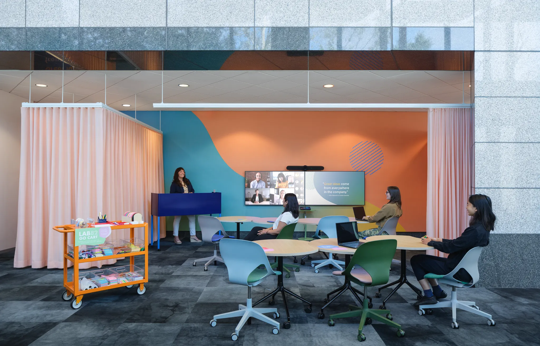 Modern workplace meeting room with colorful chairs and commercial carpet tile flooring