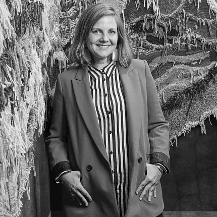 Diverse carpet textures for modern interiors Woman standing beside textured carpet samples in showroom