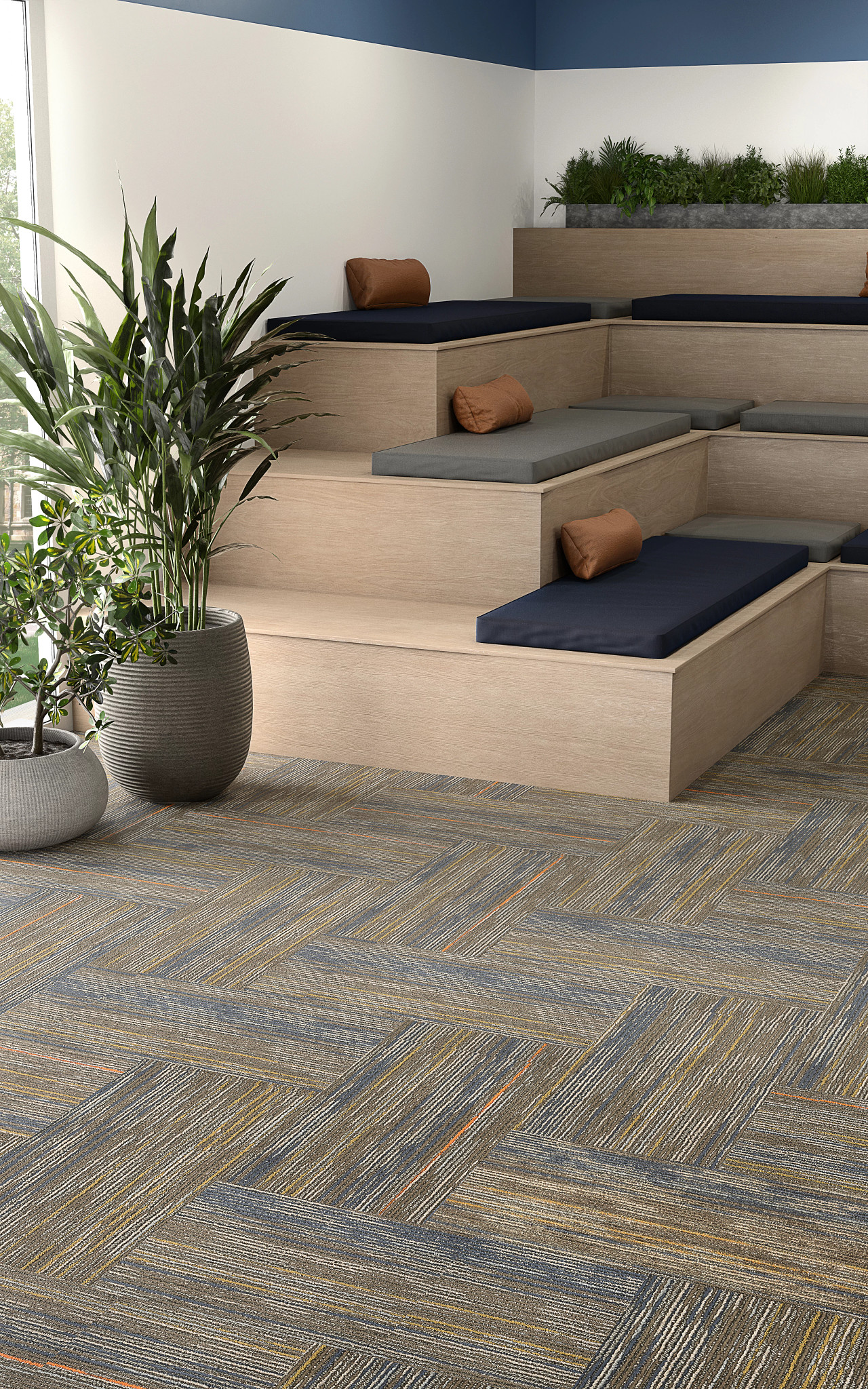 
  "room with tiered seating and plants with 18x36 inch soft surface carpet tiles in shades of blue gray and orange"
)