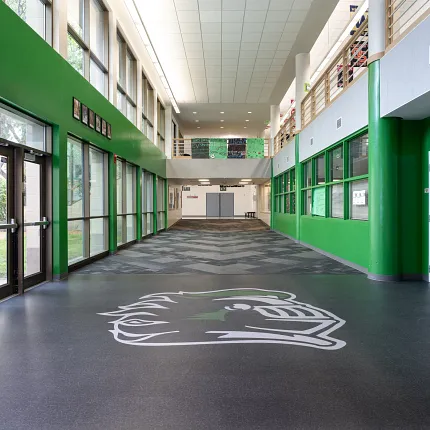 Durable LVT flooring for educational spaces Heavy commercial luxury vinyl tile flooring in an education facility hallway