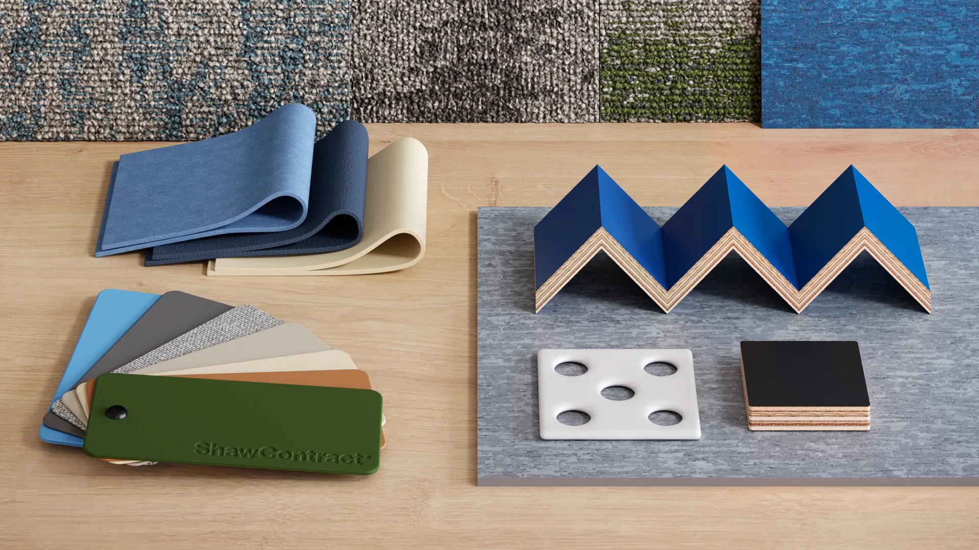 Swatch samples of ShawContract flooring materials including blue, beige, and green color options on a wooden surface