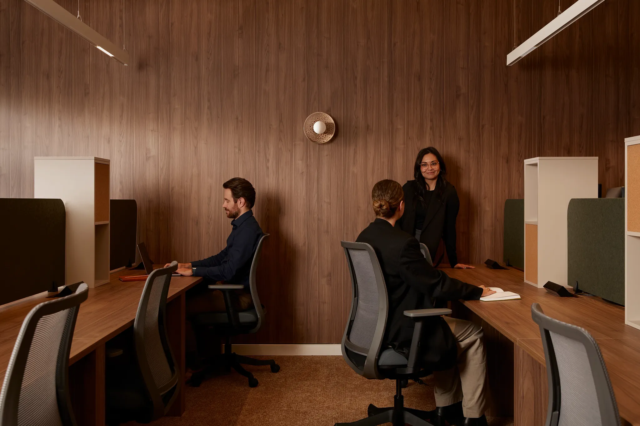 Modern office with wood paneling and carpet flooring