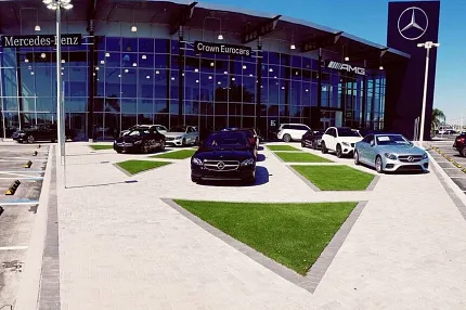 Luxury car showroom exterior view Mercedes-Benz dealership with cars displayed outside