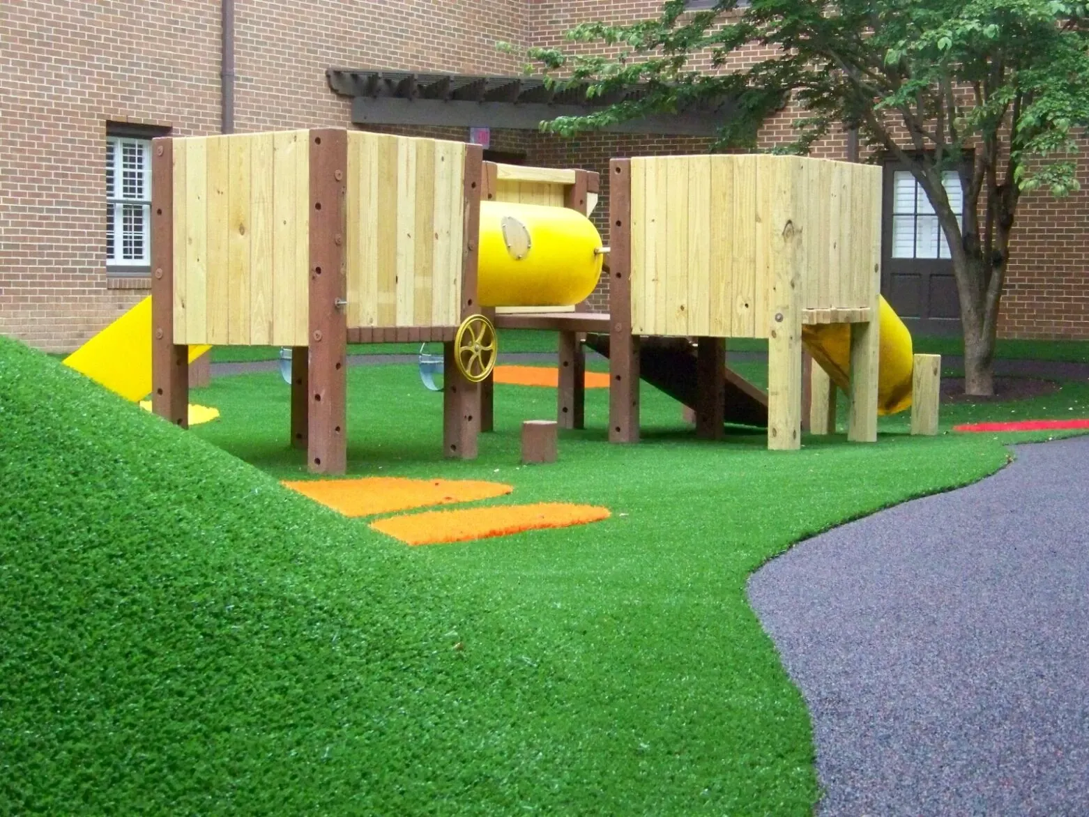 Playground with artificial grass and wooden structures