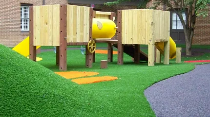 Durable artificial grass for outdoor play areas Playground with artificial grass and wooden structures