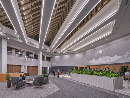 Contemporary Workplace Lobby with Grey Commercial Carpet Flooring Modern workplace lobby with high ceilings, contemporary lighting, and grey commercial carpet flooring