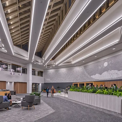 Contemporary Workplace Lobby with Grey Commercial Carpet Flooring Modern workplace lobby with high ceilings, contemporary lighting, and grey commercial carpet flooring