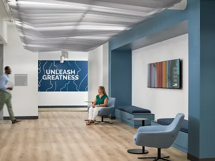 Contemporary Office Waiting Area with Light Wood Flooring Modern office waiting area with light wood flooring, blue and white walls, and contemporary furniture