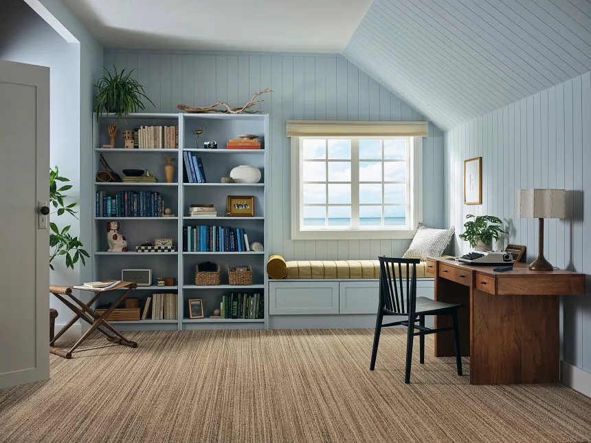 Stylish neutral carpet for modern living spaces Textured carpet in neutral tones with a black leather chair