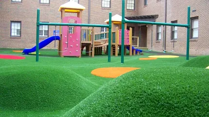 Durable artificial turf for playgrounds Playground with artificial grass and play structures