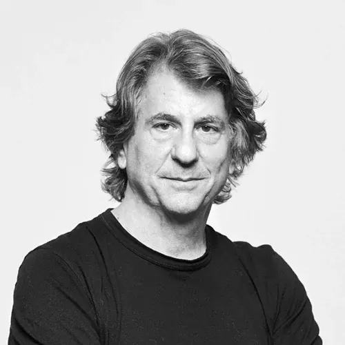 Portrait of a man with medium-length hair wearing a black shirt