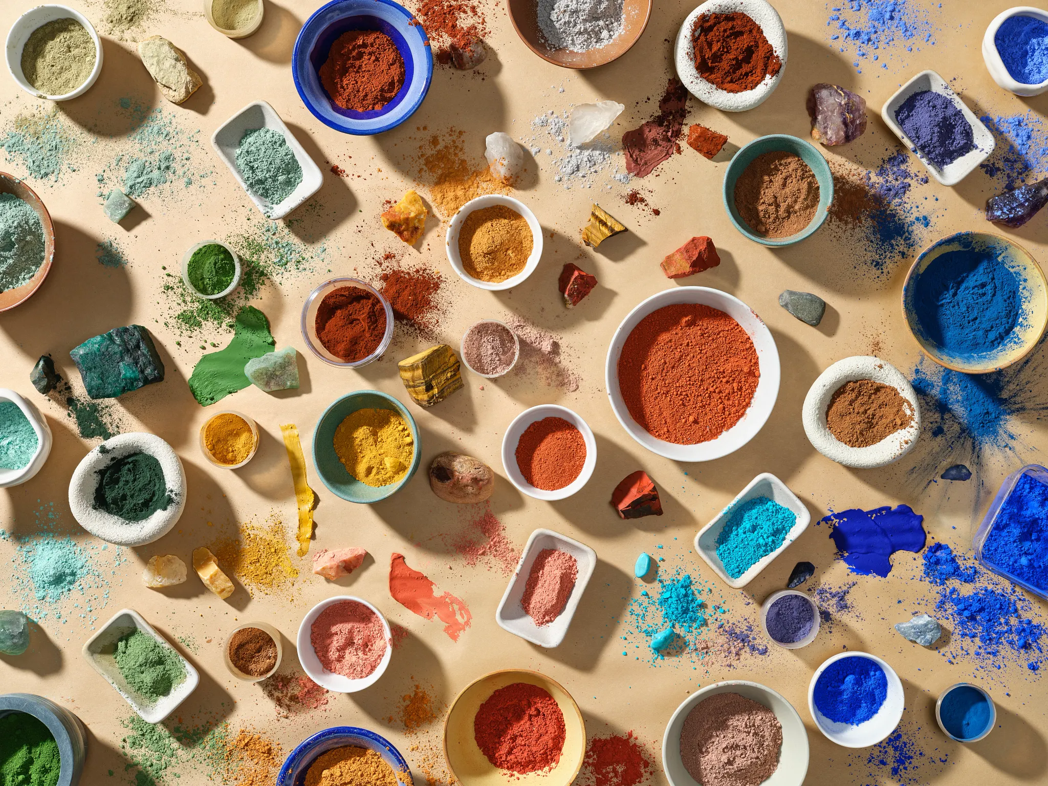 Assorted colorful pigments in bowls and dishes