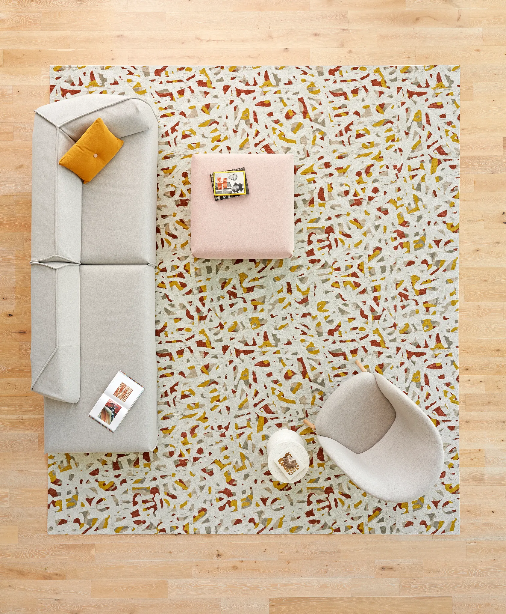 birds eye view of a rug, couch, and armchair