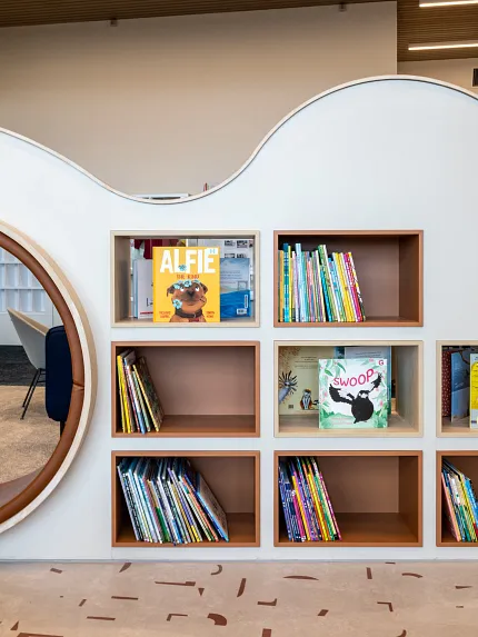 Stylish library design featuring contemporary flooring Modern library interior with unique shelving and patterned flooring