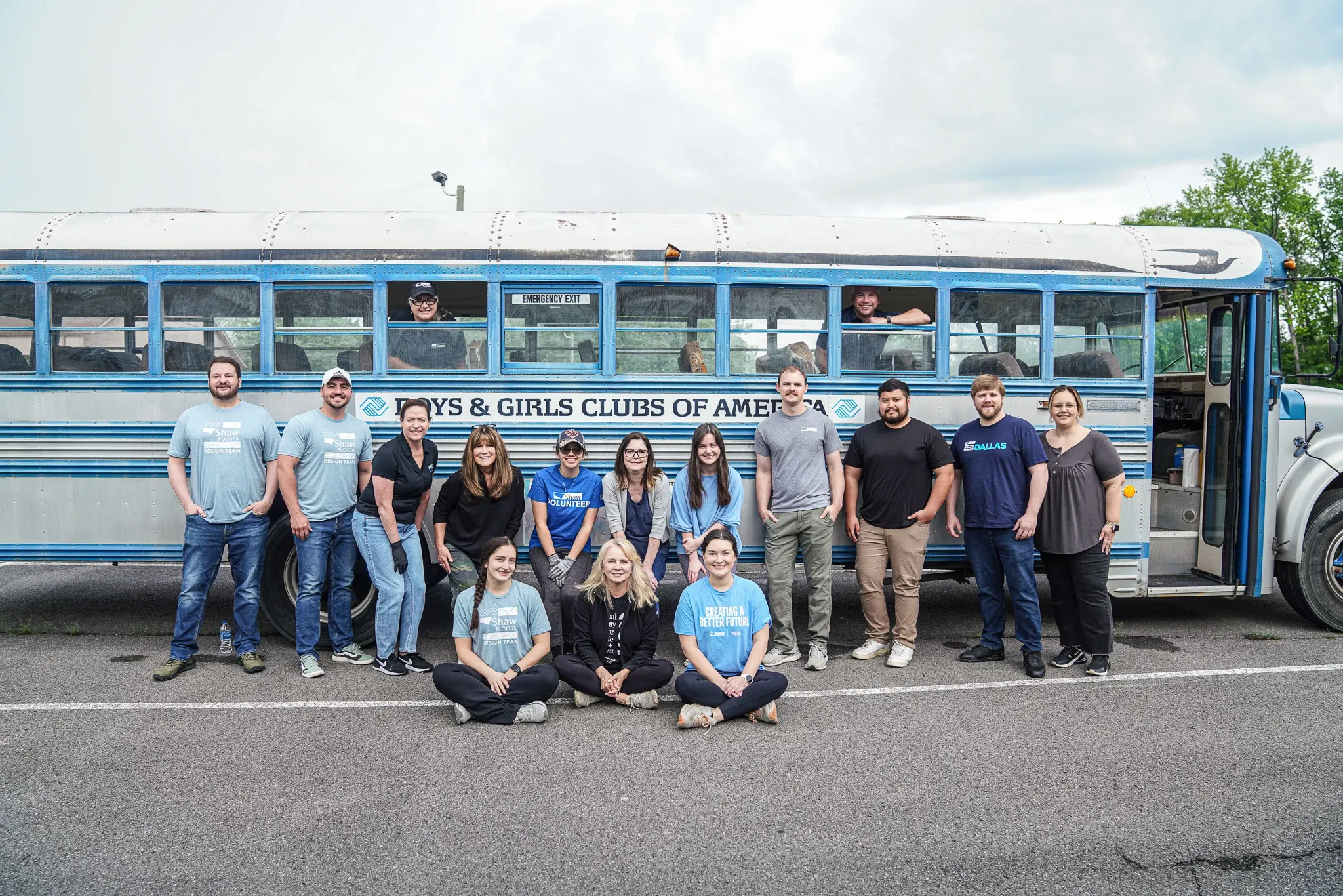 Group of people standing in front of Boys & Girls Clubs of America bus