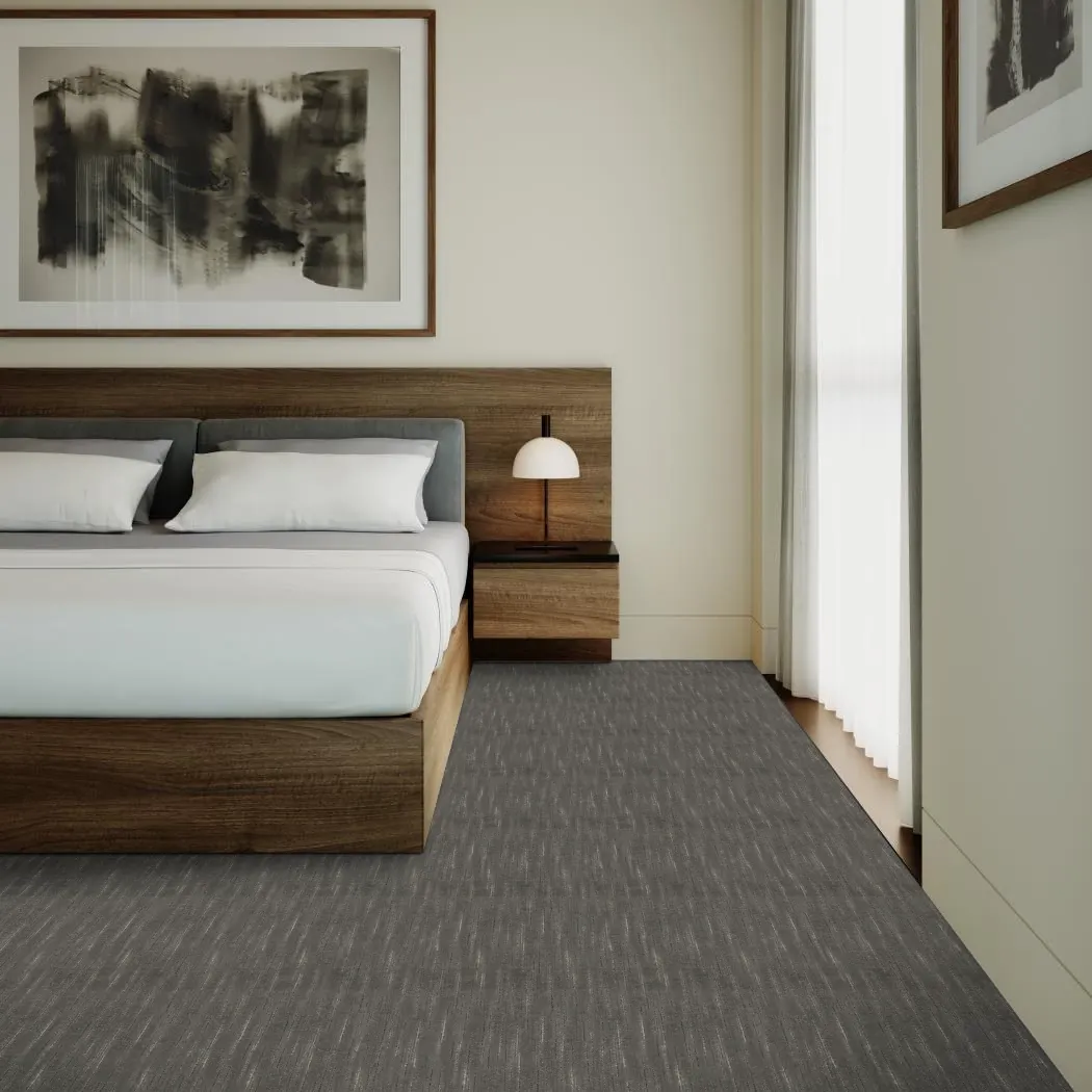Modern bedroom with a wooden bed frame, white bedding, and gray flooring
