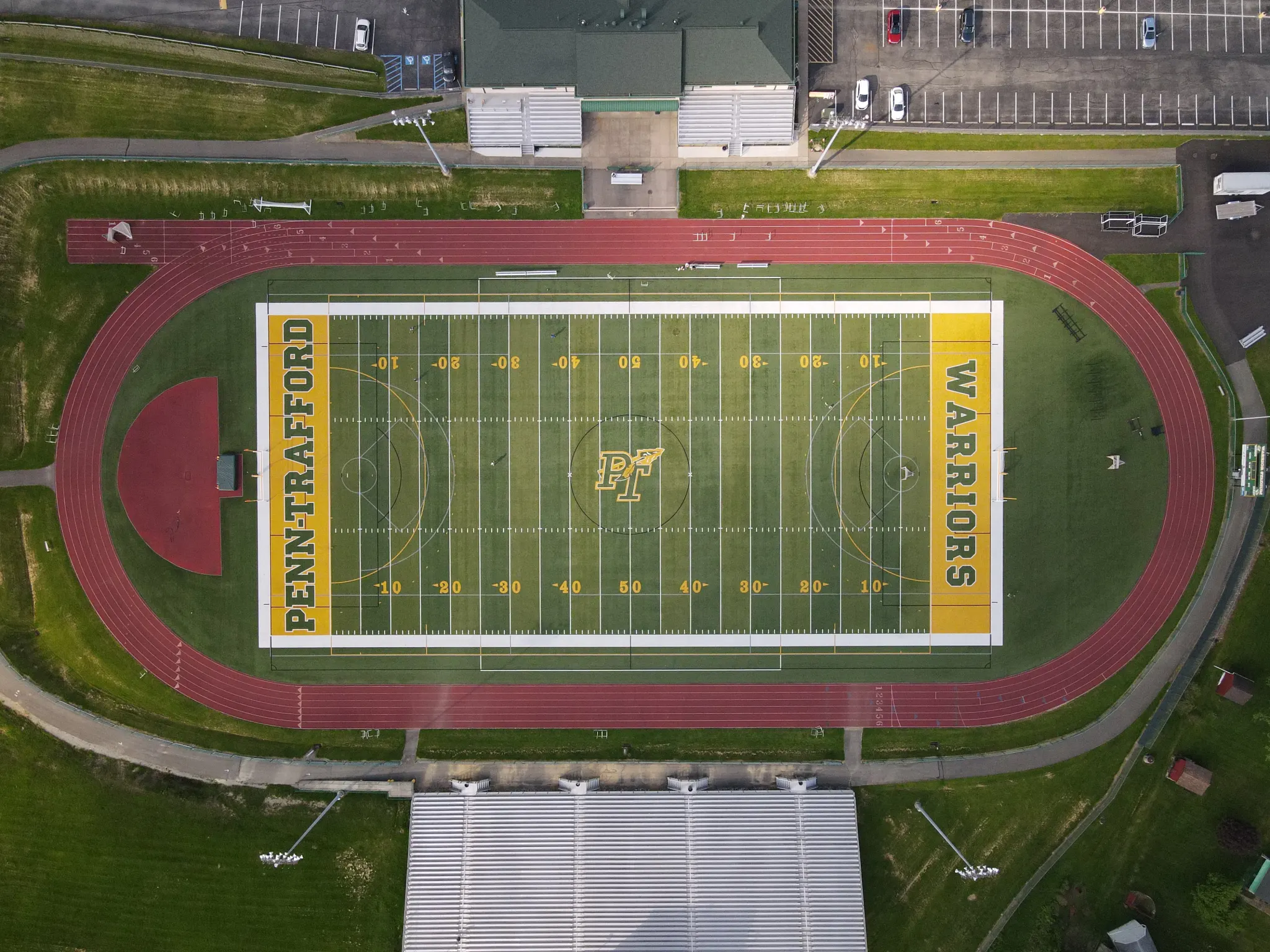 Aerial view of a sports field with track and bleachers