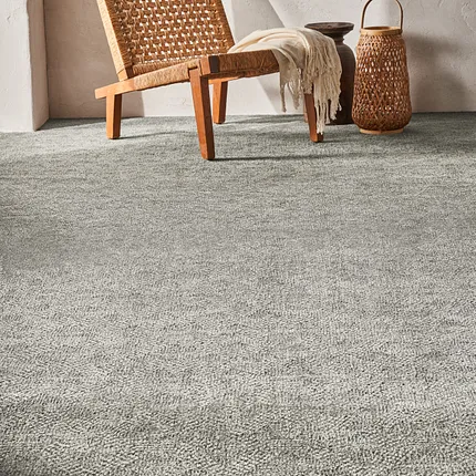 Soft Surface Grey Carpet - Anderson Tuftex 12 ft Width Cozy room scene with a woven chair and basket on a soft grey carpet