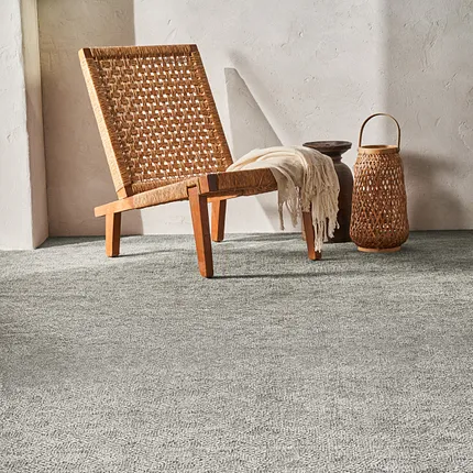 Soft Surface Grey Carpet - Anderson Tuftex 12 ft Width Cozy room scene with a woven chair and basket on a soft grey carpet