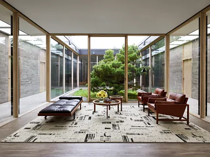 Contemporary living room with patterned rug and leather seating Embrace in High Atlas