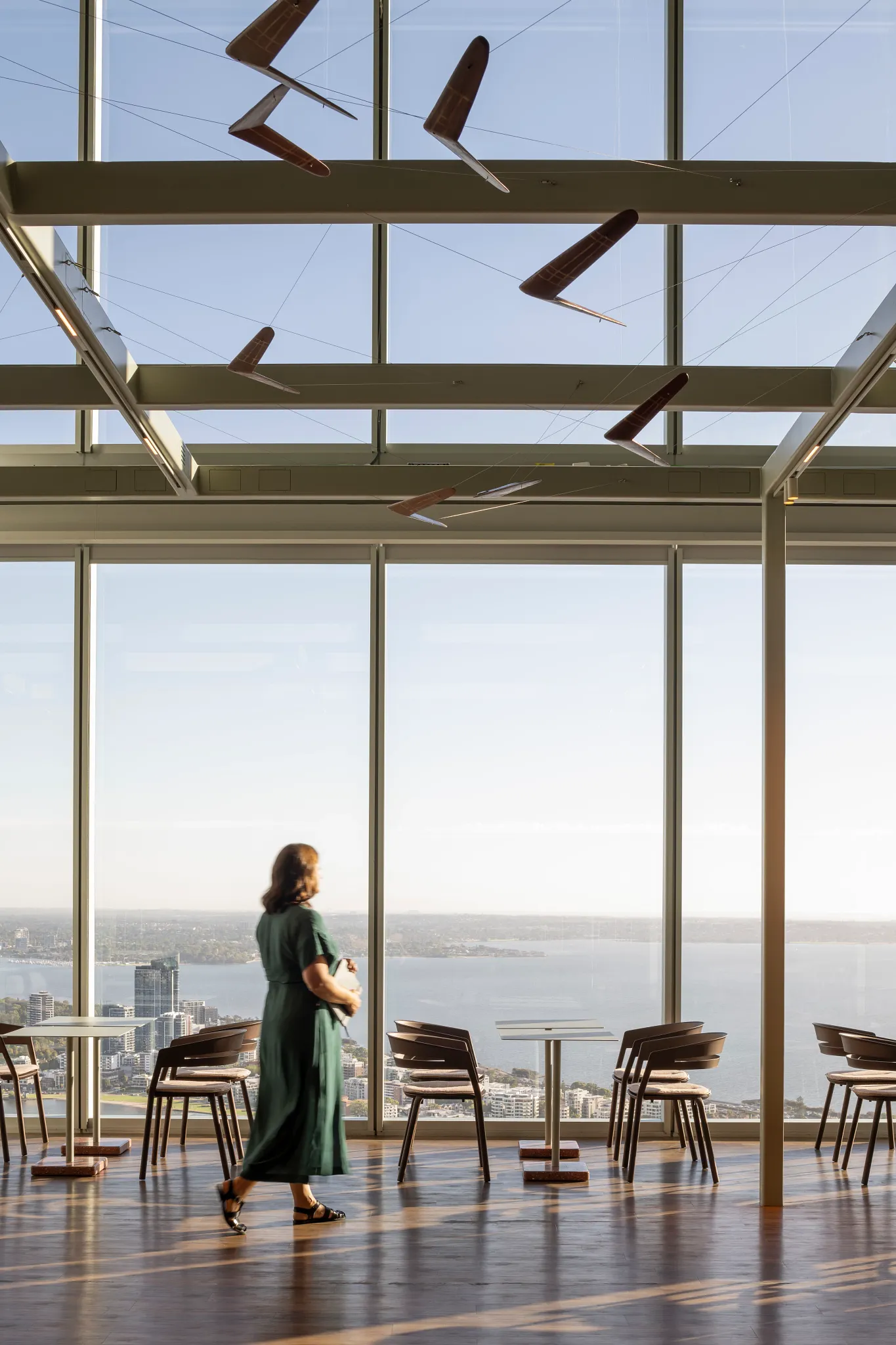 Modern office space with wooden flooring and panoramic city view