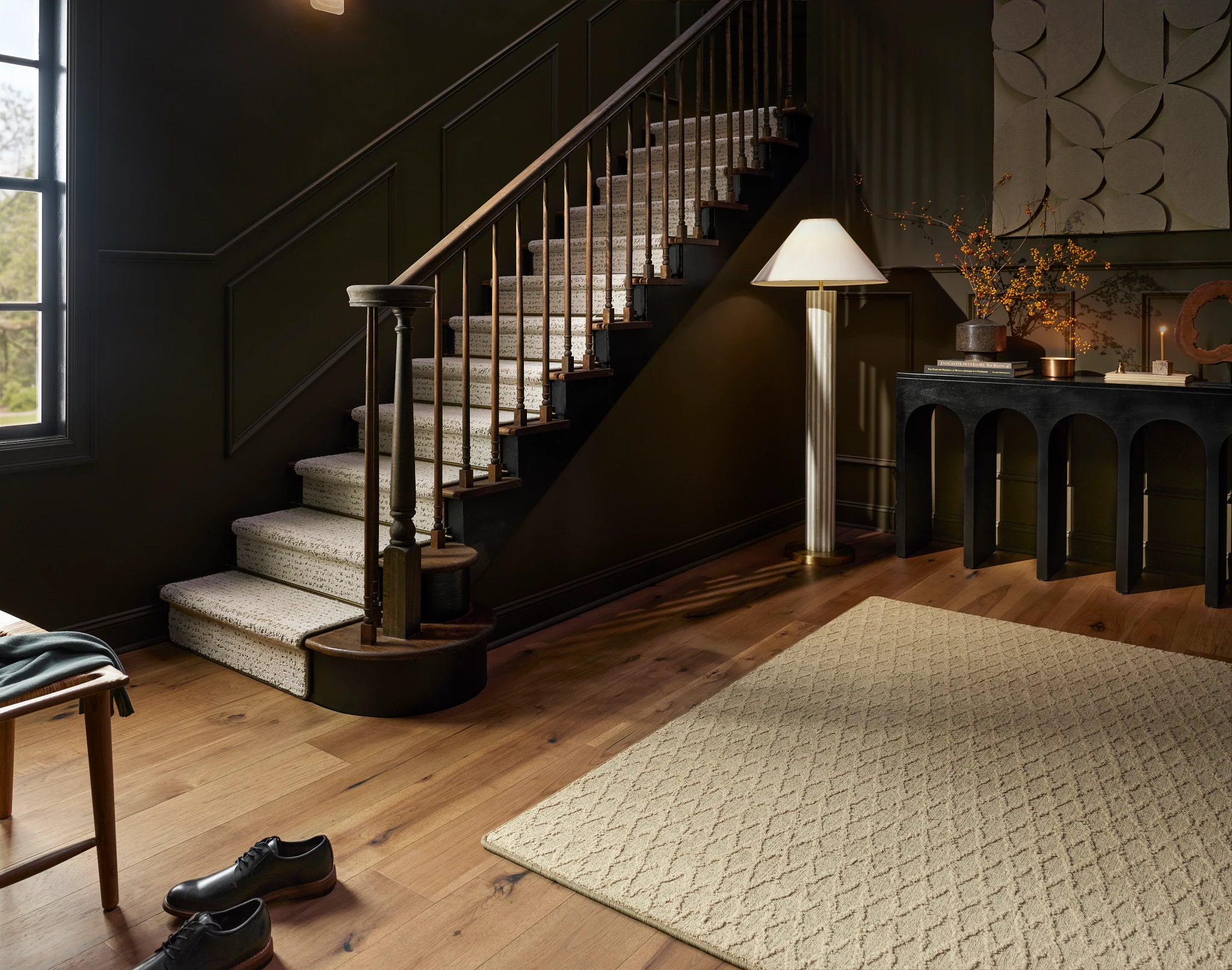 Elegant interior with beige carpet and hardwood flooring in a stylish home