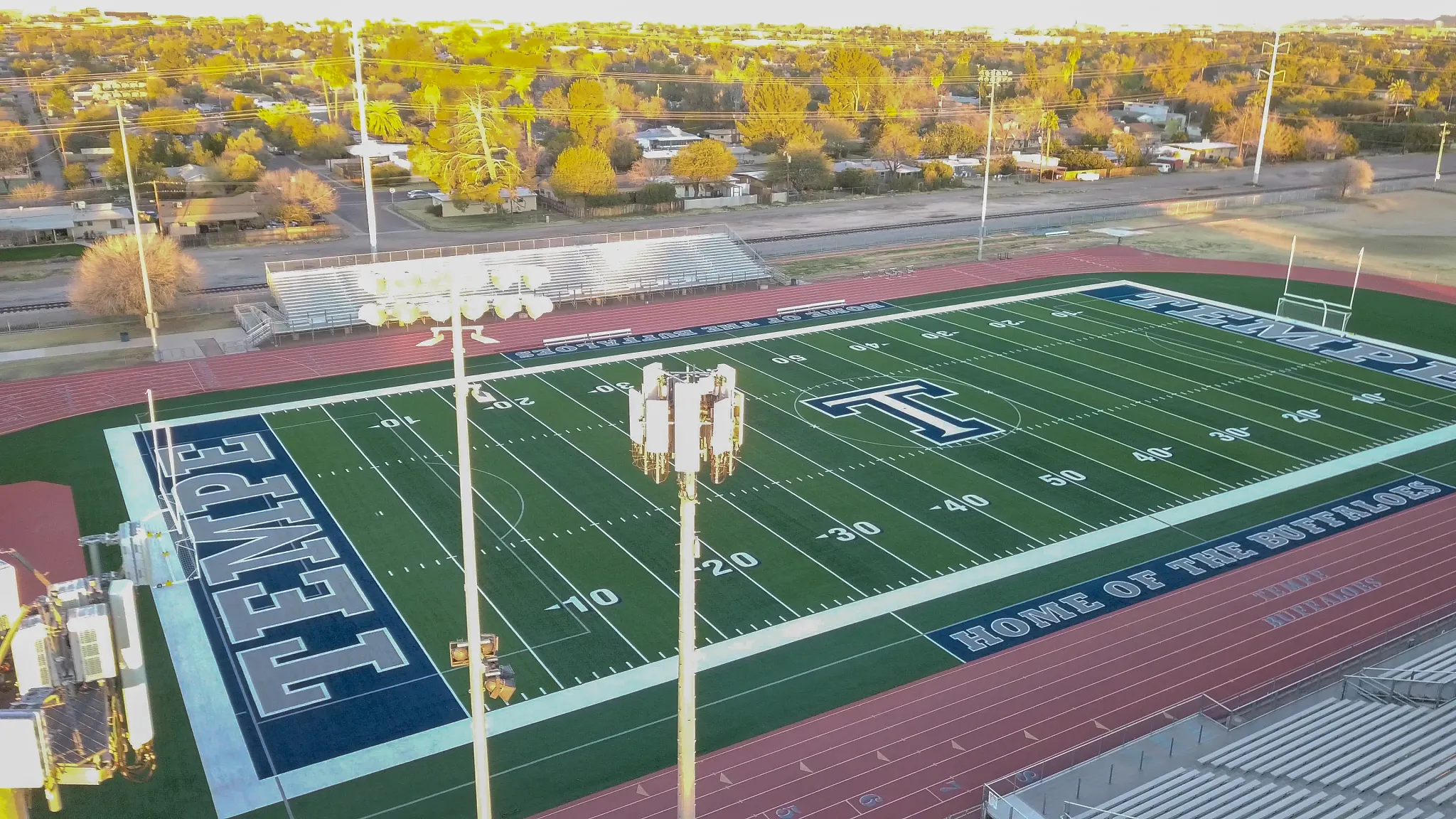 Aerial view of a football field with track and bleachers