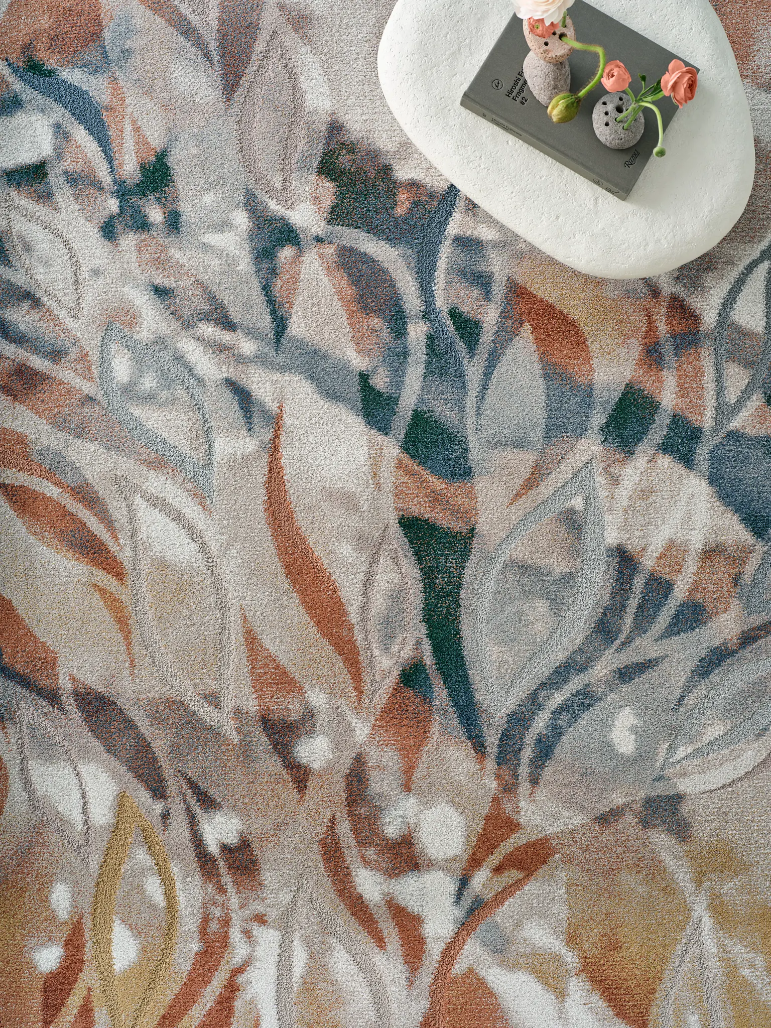 Floral patterned carpet with shades of blue, orange, and beige