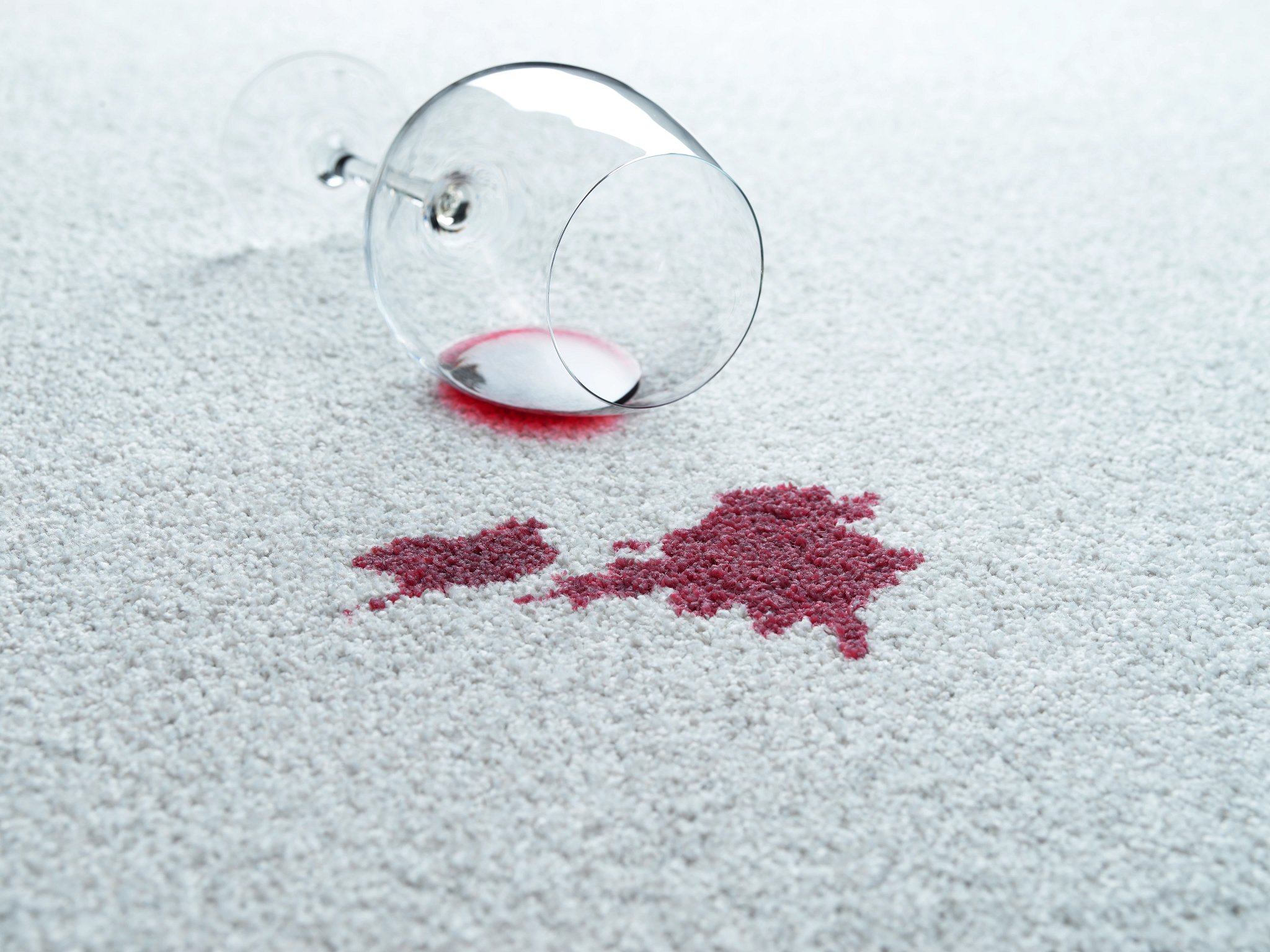 Spilled wine on white carpet