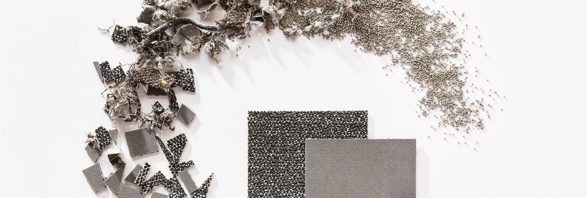 Assorted commercial carpet tile swatches in gray and black