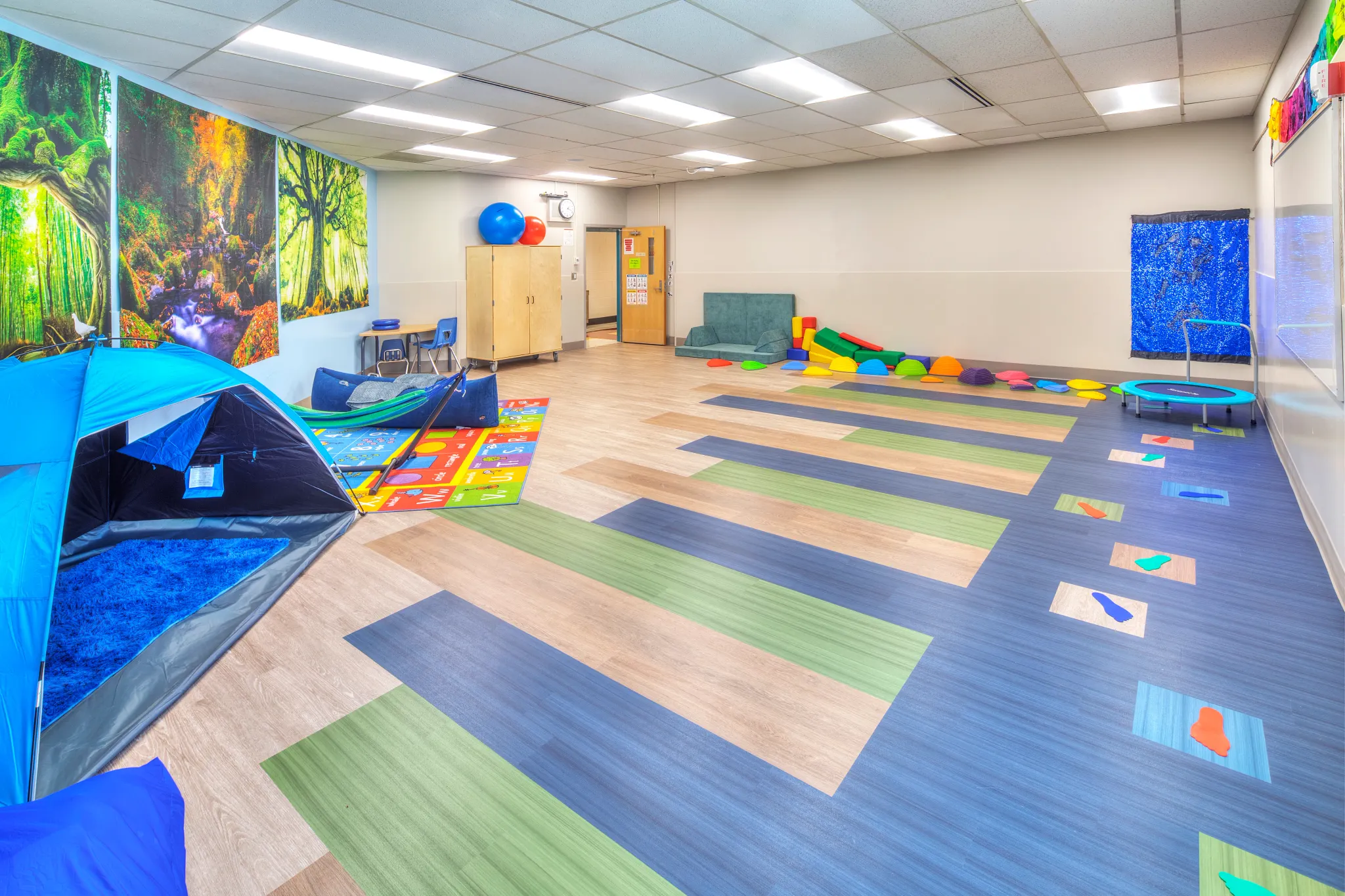 Classroom space with green, blue, wood visual LVT flooring