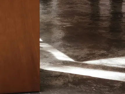 Floor Preparation for Commercial Flooring Installation Floor preparation process with adhesive removal tool and worn sneakers visible