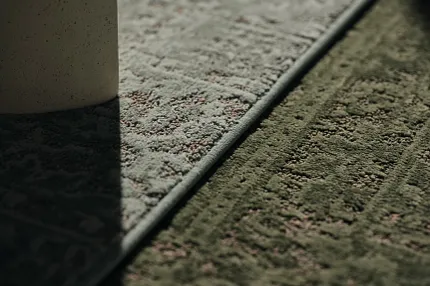 Stylish broadloom carpet in gray and green for modern interiors Close-up of broadloom carpet in gray and green tones
