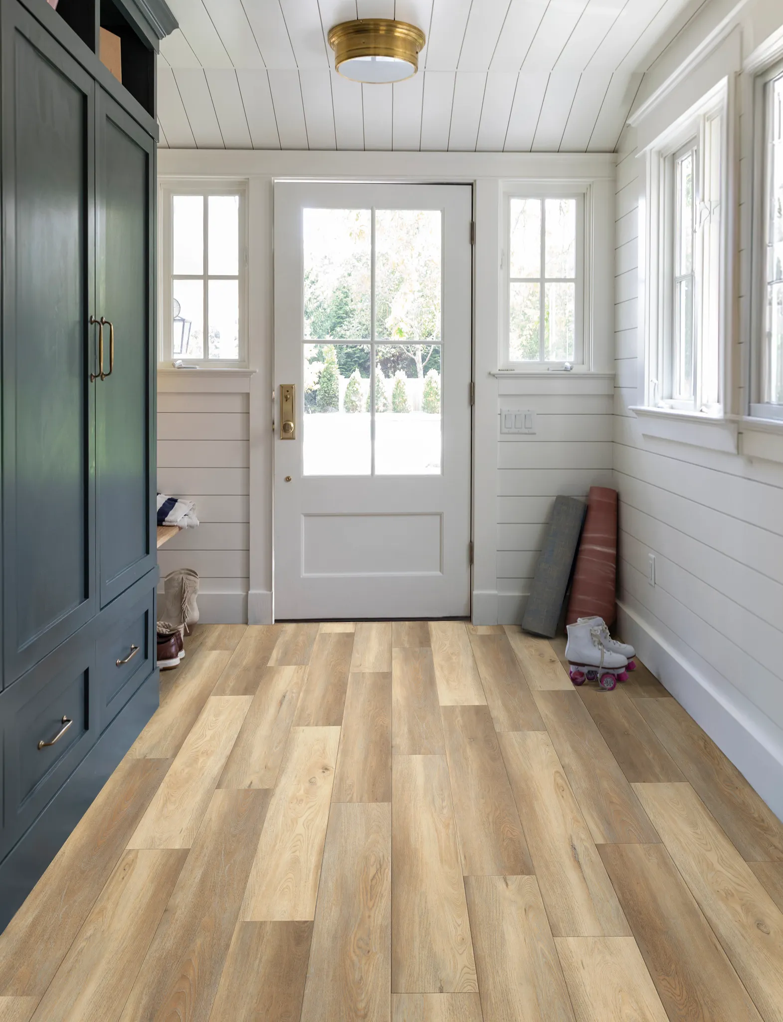 Entryway with light oak luxury vinyl plank flooring, showcasing a cozy and practical home environment