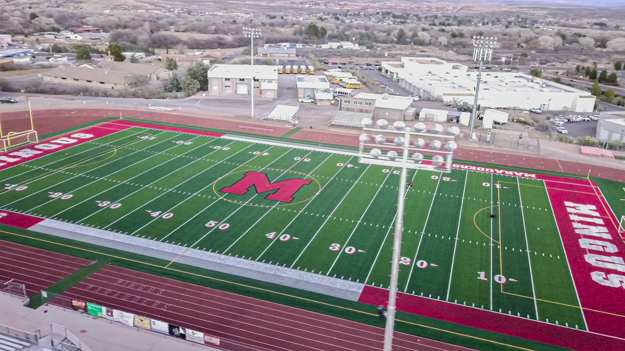 Aerial view of a football field with red and green turf