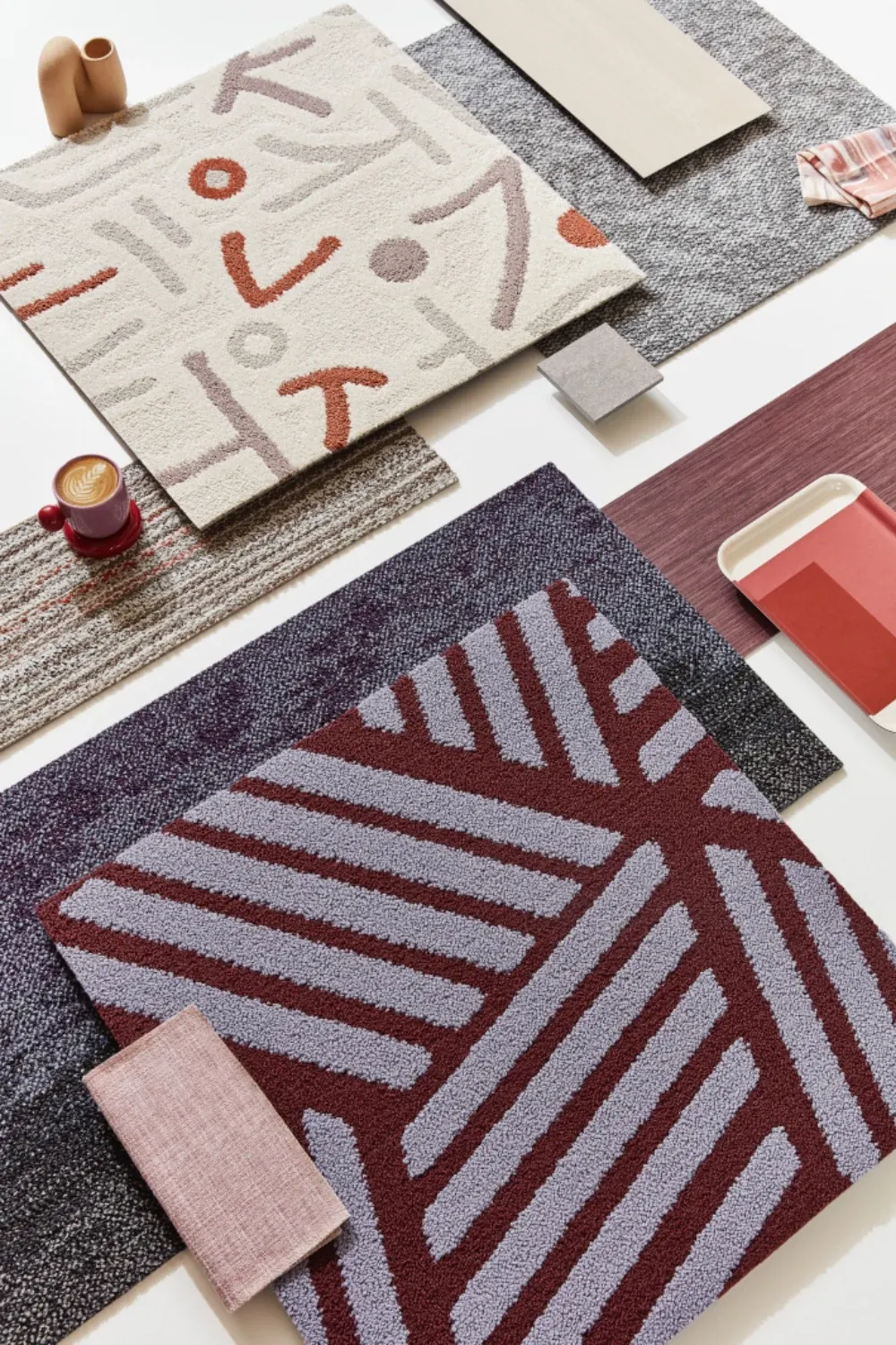 Assorted carpet swatches in beige, red, and gray patterns