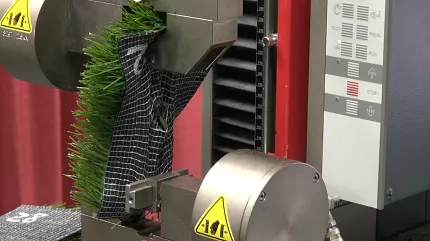 Laboratory testing of synthetic turf for quality assurance Artificial grass undergoing durability testing in a laboratory