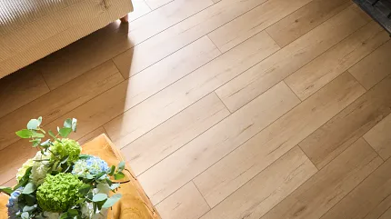 Light Wood Look Vinyl Flooring - Coretec Residential WPC 48.03x7.09 inch Light wood look vinyl flooring in a cozy living room with a beige sofa and a wooden table with a floral arrangement