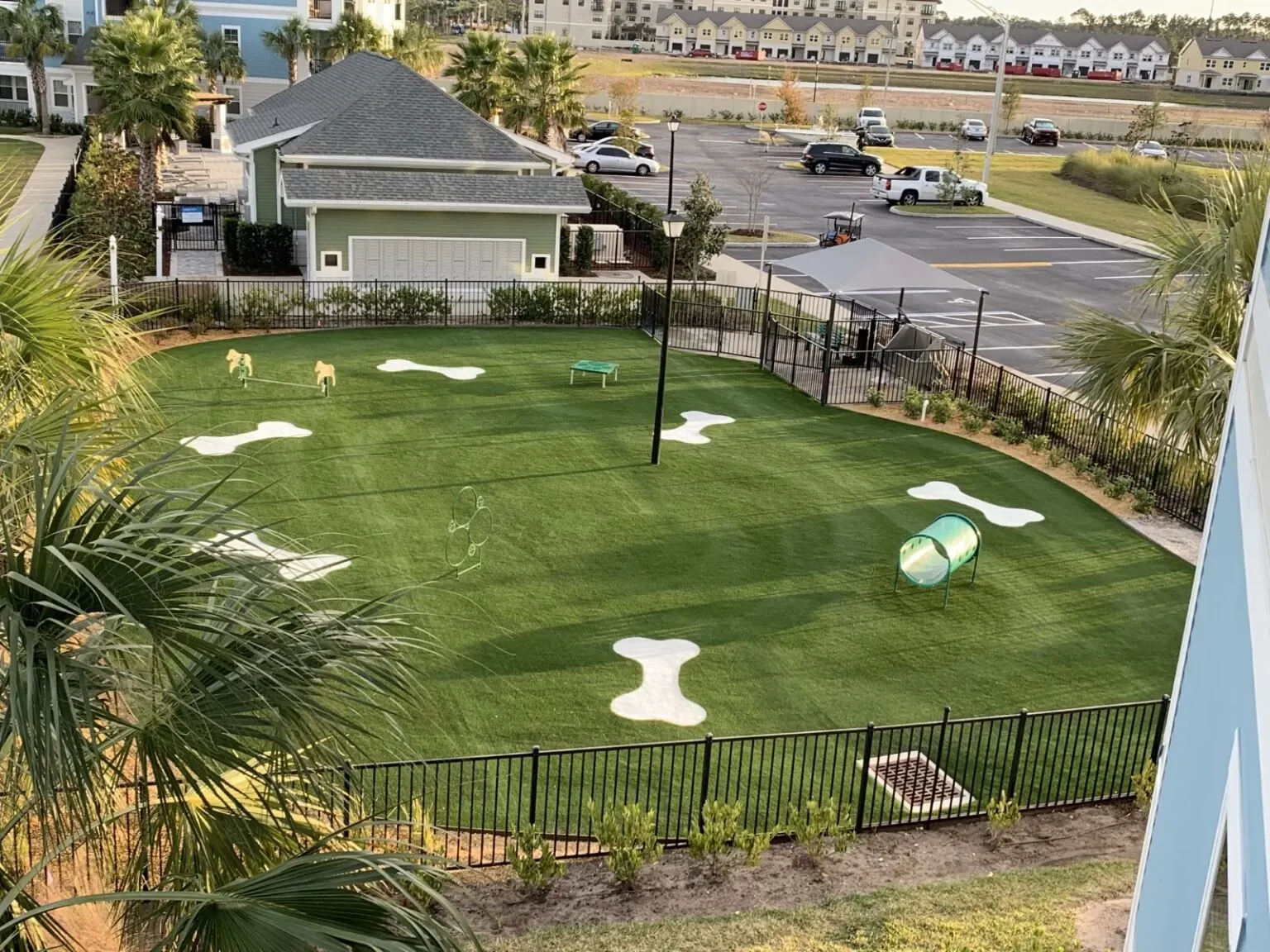 Outdoor dog park with artificial grass and play equipment