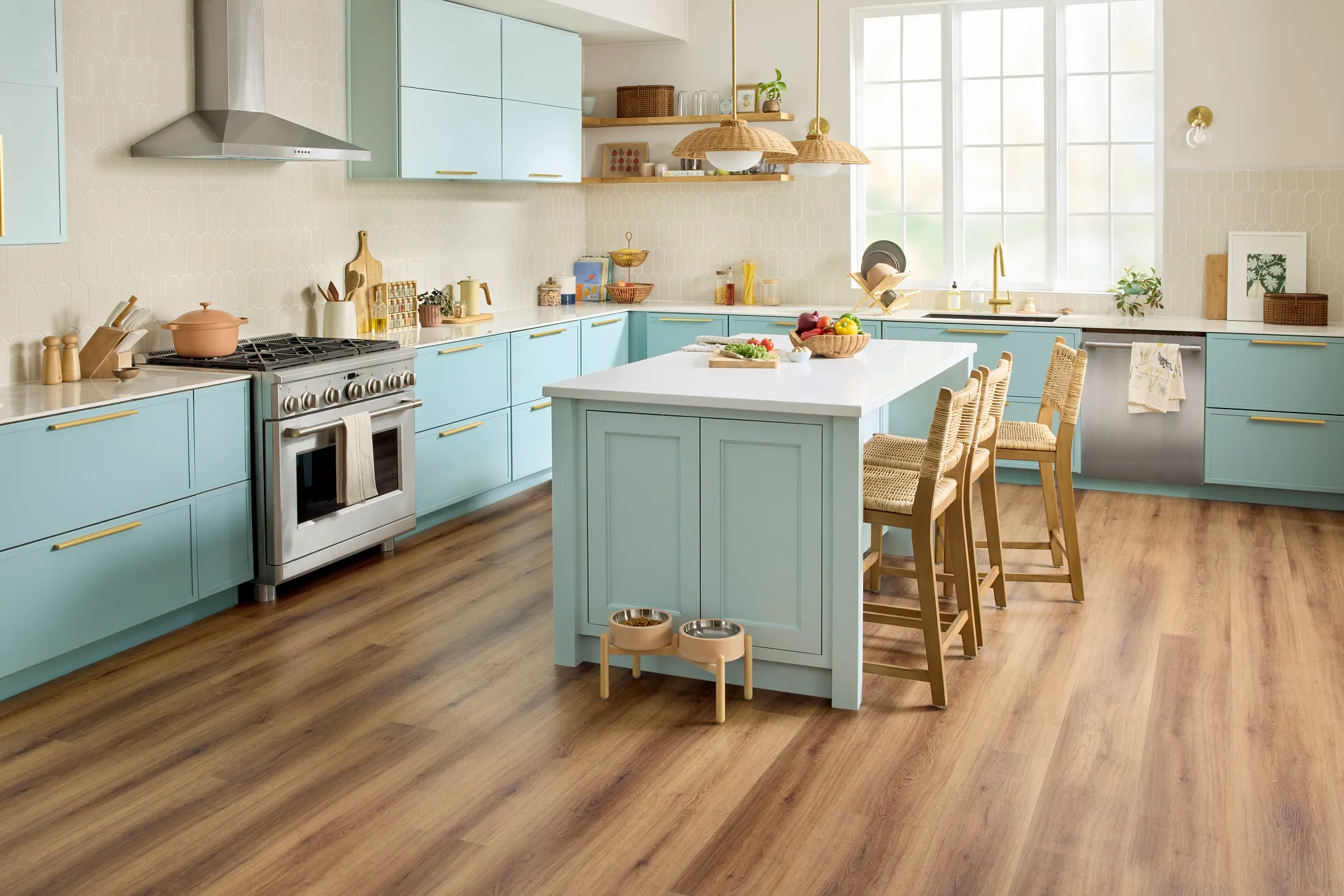 Modern kitchen with light oak hardwood flooring, white cabinetry, and a navy blue island