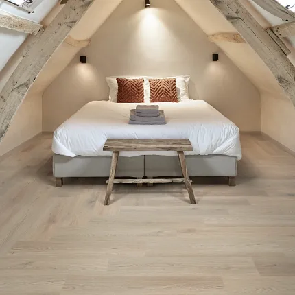 Beige Luxury Vinyl Plank Flooring in Attic Bedroom - Sound Core® Technology Cozy attic bedroom with beige luxury vinyl plank flooring featuring Sound Core® technology, 35.905x8.976 inch dimensions