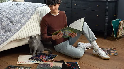 Stylish and durable vinyl flooring for modern living spaces Coretec Residential WPC vinyl flooring in a cozy bedroom with records and a cat