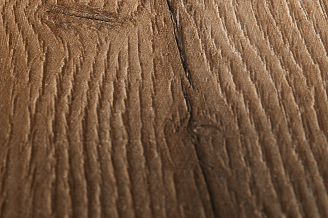 A close-up detail shot of vinyl flooring wood grain texture