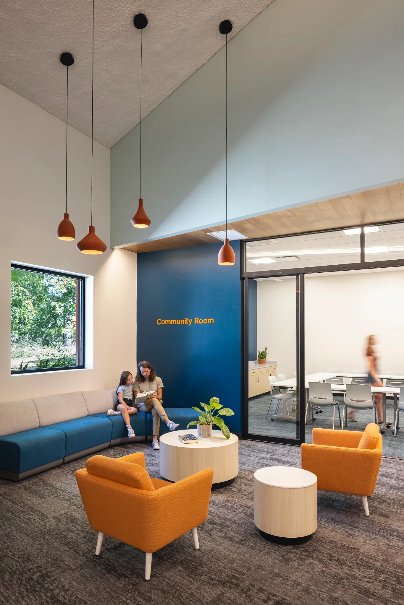 Community room with modern seating and commercial carpet flooring in an education facility