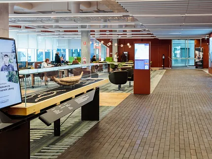 University of Tasmania Library and Learning Environment Design | Shaw Contract University of Tasmania library interior featuring a cultural display, custom patterned carpet flooring and collaborative learning spaces.